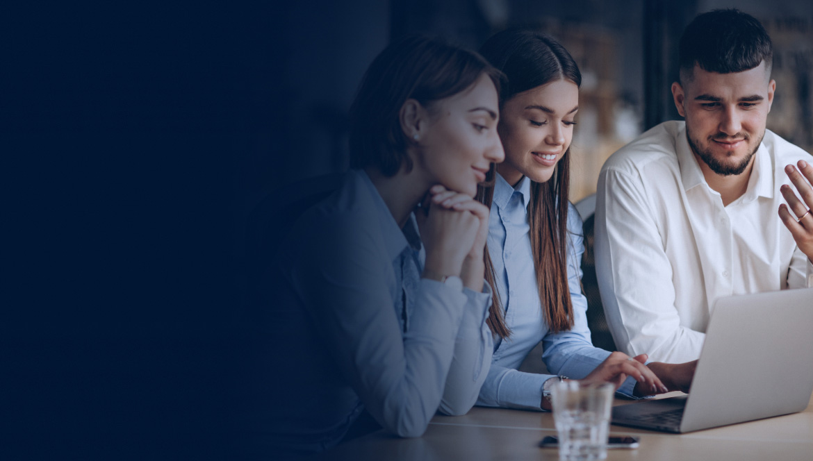 two men and a woman looking at a laptop screen